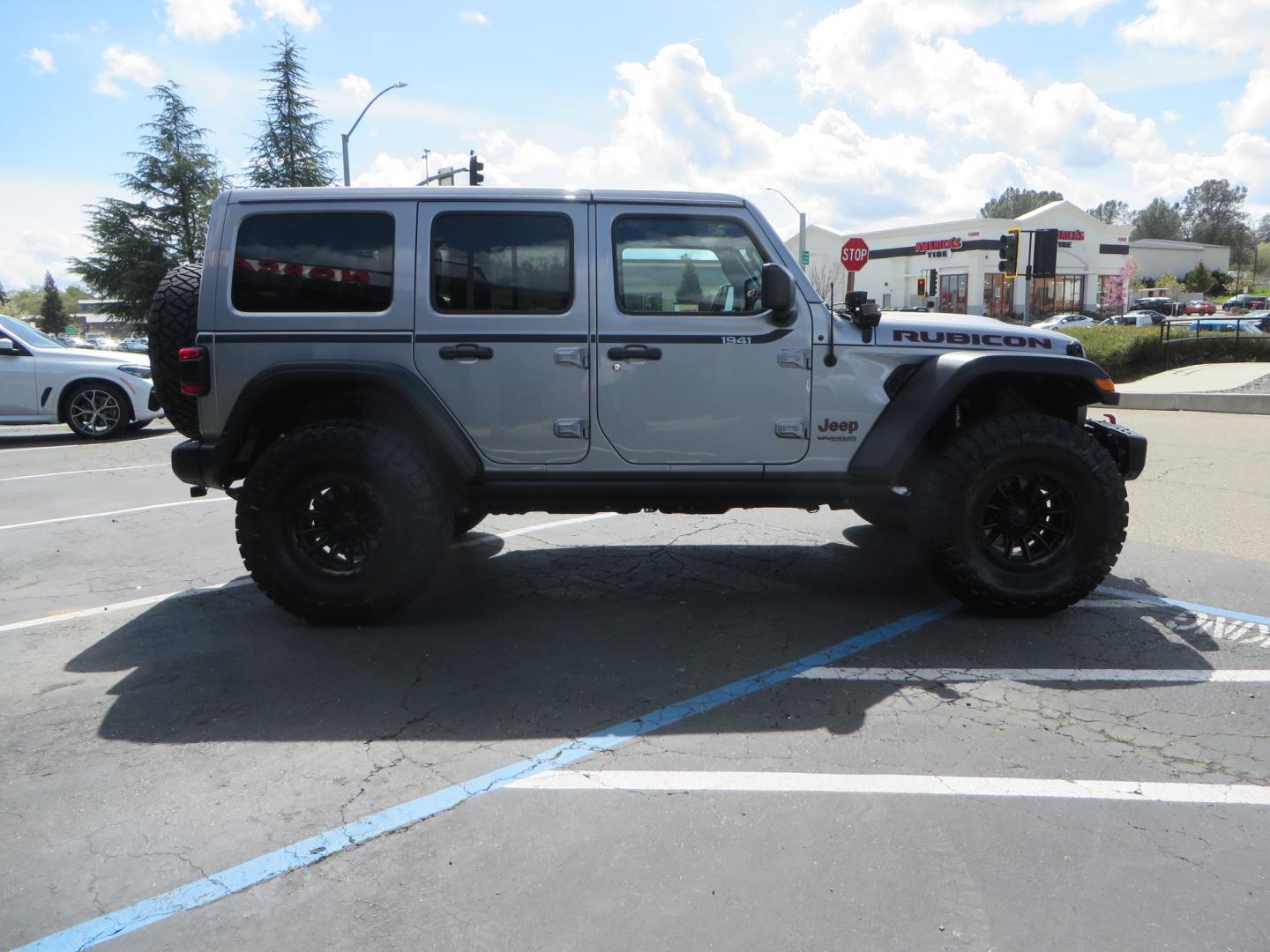 2021 SILVER /BLACK Jeep Wrangler Unlimited Rubicon (1C4HJXFG7MW) with an 3.6L V6 DOHC 24V FFV engine, 6A transmission, located at 2630 Grass Valley Highway, Auburn, CA, 95603, (530) 508-5100, 38.937893, -121.095482 - Features - Zone Offroad 3" Lift kit, Fox shocks, 37" Nitto Ridge Grappler tires, 17" Fuel Piston wheels, Warn winch, KC led lights, Voswitch switches, Teraflex HD tire relocation, Fire extinguisher, High Lift Jack, Shovel, Axe, Jumper Cables, and flat towable. - Photo#3